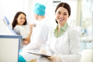 The dentist checks the patient's information before recommending the proper dental treatment.