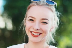 The woman smiles at the camera.