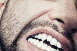 attractive with sharp canine teeth